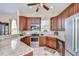 Modern kitchen with stainless steel appliances, granite countertops, and dark wood cabinetry at 6801 Nowiki Ave, Hudson, FL 34667