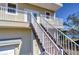 Staircase leading to the upper level balcony, with lovely architectural details at 6801 Nowiki Ave, Hudson, FL 34667