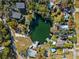 An aerial view of a waterfront community with homes surrounding a serene body of water at 7256 Westwind St, Weeki Wachee, FL 34607
