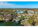 An aerial view of the property highlighting its waterfront location and nearby docks with ocean in background at 7256 Westwind St, Weeki Wachee, FL 34607