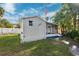 Charming cottage in backyard with a screened in porch and lush landscaping at 7256 Westwind St, Weeki Wachee, FL 34607