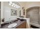 This bathroom features granite counters and a glass enclosed shower and bath tub at 7256 Westwind St, Weeki Wachee, FL 34607