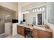 This spacious bathroom has double sinks, a vanity, and a walk-in shower at 7256 Westwind St, Weeki Wachee, FL 34607