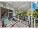 Spacious screened-in patio with comfortable seating, ceiling fan, and serene outdoor views at 7256 Westwind St, Weeki Wachee, FL 34607