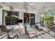 Cozy covered patio with ceiling fan, comfortable seating, and sliding doors leading to the interior at 7256 Westwind St, Weeki Wachee, FL 34607