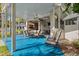 Large covered patio with a ceiling fan, outdoor seating, and a convenient bar area for entertaining at 7256 Westwind St, Weeki Wachee, FL 34607