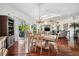 Dining room featuring hardwood floors and access to a large outdoor patio and landscaped yard at 7256 Westwind St, Weeki Wachee, FL 34607