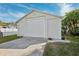 Exterior shot of a detached garage with a clean white door and a well-maintained driveway at 7256 Westwind St, Weeki Wachee, FL 34607