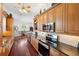Bright gourmet kitchen with stainless appliances, granite countertops, and hardwood floors at 7256 Westwind St, Weeki Wachee, FL 34607