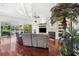 Bright living room features hardwood floors, fireplace, and sliding glass doors to patio at 7256 Westwind St, Weeki Wachee, FL 34607