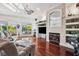 Inviting living room with hardwood floors, fireplace, and outdoor views at 7256 Westwind St, Weeki Wachee, FL 34607