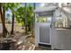Outdoor shower with a private enclosure, surrounded by lush landscaping and a walkway at 7256 Westwind St, Weeki Wachee, FL 34607