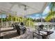This house has a large porch with ceiling fans, lots of chairs and a view of the water at 7256 Westwind St, Weeki Wachee, FL 34607