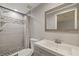 Stylish bathroom featuring shower with decorative tiles and a large vanity mirror at 7431 Abington Ave, New Port Richey, FL 34655