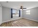 Bedroom featuring neutral paint, wood-look flooring, and a modern ceiling fan at 7431 Abington Ave, New Port Richey, FL 34655