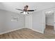 Bedroom featuring neutral paint, wood-look flooring, and a modern ceiling fan at 7431 Abington Ave, New Port Richey, FL 34655
