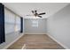 Cozy bedroom featuring neutral paint, wood-look flooring, and a modern ceiling fan at 7431 Abington Ave, New Port Richey, FL 34655