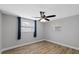 Bright bedroom with a modern fan, fresh paint and wood-look floors at 7431 Abington Ave, New Port Richey, FL 34655