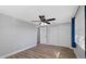 Bedroom features fresh paint, wood-look flooring, modern ceiling fan, and closet at 7431 Abington Ave, New Port Richey, FL 34655