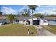 Charming single-story home with a well-maintained lawn and beautiful palm trees at 7431 Abington Ave, New Port Richey, FL 34655