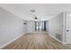 Inviting living room with new floors, wainscotting, modern lighting, and neutral color palette at 7431 Abington Ave, New Port Richey, FL 34655