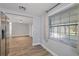 Bright living area with fresh paint, wood-look floors, and a view to the yard at 7431 Abington Ave, New Port Richey, FL 34655