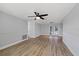 Bright living room features new flooring, wainscotting, modern ceiling fan, and access to back patio at 7431 Abington Ave, New Port Richey, FL 34655