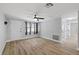 Freshly painted living room with stylish flooring, wainscotting, ceiling fan, and natural light at 7431 Abington Ave, New Port Richey, FL 34655