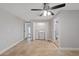 Large main bedroom featuring tiled flooring, adjoined ensuite bath, and laundry closet at 7431 Abington Ave, New Port Richey, FL 34655