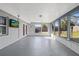 Bright sunroom with large windows, an exterior exit, and a wall-mounted television at 7431 Abington Ave, New Port Richey, FL 34655