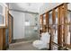 Bathroom featuring a glass shower, a toilet, and exposed studs in mid-renovation at 8225 Channel Dr, Port Richey, FL 34668