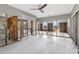 Bright, spacious living room with tile flooring, large windows, ceiling fan, and exposed studs at 8225 Channel Dr, Port Richey, FL 34668
