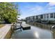 Waterfront view featuring a dock and canal with condos in the background at 8225 Channel Dr, Port Richey, FL 34668
