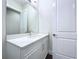 Bright bathroom with modern white vanity, quartz countertop, and large mirror for a clean aesthetic at 9065 Mississippi Run, Weeki Wachee, FL 34613