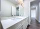 Spacious bathroom with double sinks, quartz countertop, and modern lighting above large mirror at 9065 Mississippi Run, Weeki Wachee, FL 34613