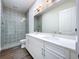Modern bathroom with double vanity, quartz countertop and beautifully tiled shower with glass door at 9065 Mississippi Run, Weeki Wachee, FL 34613