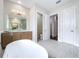 Bathroom featuring vanity, toilet room and an entrance to a walk-in closet at 9065 Mississippi Run, Weeki Wachee, FL 34613