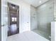 Clean, tiled, modern bathroom with glass enclosed shower at 9065 Mississippi Run, Weeki Wachee, FL 34613