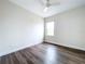 Bedroom featuring wood-look floors, light walls, ceiling fan and a window for natural light at 9065 Mississippi Run, Weeki Wachee, FL 34613