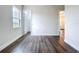 Bedroom featuring wood look floors, light walls, and doors to closets and other rooms at 9065 Mississippi Run, Weeki Wachee, FL 34613