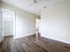 Bright, unfurnished bedroom featuring wood floors, a ceiling fan and access to the Primary closet at 9065 Mississippi Run, Weeki Wachee, FL 34613
