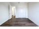 Bedroom featuring wood-look floors, a closet, and an open doorway to the hall at 9065 Mississippi Run, Weeki Wachee, FL 34613