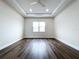 Spacious bedroom with tray ceiling, ceiling fan, and hardwood flooring at 9065 Mississippi Run, Weeki Wachee, FL 34613