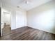 This bedroom features neutral walls, a ceiling fan, wood floors, and closet for ample storage space at 9065 Mississippi Run, Weeki Wachee, FL 34613