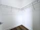 This walk-in closet has wood-look floors and ventilated shelving for storage at 9065 Mississippi Run, Weeki Wachee, FL 34613