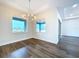 Bright dining room featuring modern chandelier and a large window with neighborhood views at 9065 Mississippi Run, Weeki Wachee, FL 34613