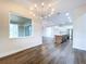 Dining room with wood floors, modern lighting fixtures, and large window to let in light at 9065 Mississippi Run, Weeki Wachee, FL 34613