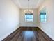 Elegant dining room with modern chandelier and large windows providing natural light at 9065 Mississippi Run, Weeki Wachee, FL 34613