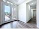 Foyer featuring double glass doors, a view to a bathroom, and dark wood flooring at 9065 Mississippi Run, Weeki Wachee, FL 34613