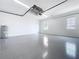 A spacious garage features epoxy floors, an automatic door opener, and two windows at 9065 Mississippi Run, Weeki Wachee, FL 34613
